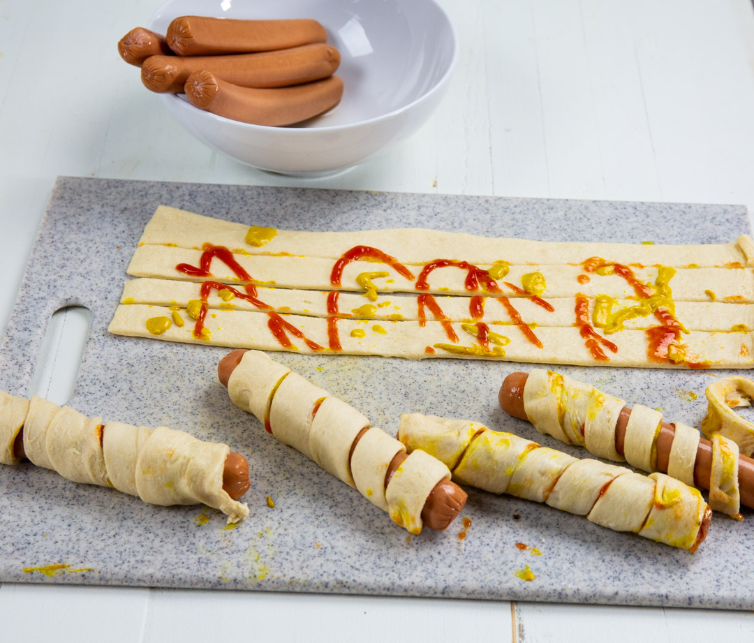 Crescent dough wrapped around hot dogs.