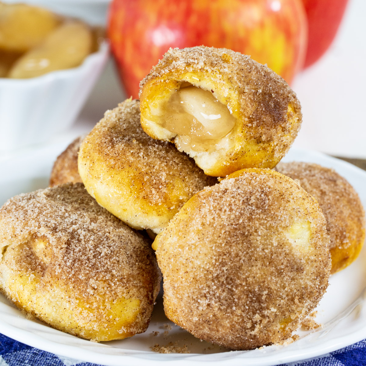 Air Fryer Apple Pie Bites with a bite out of one to show inside.