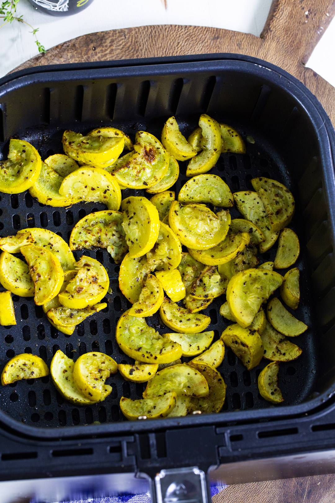 Cooked squash in air fryer basket.