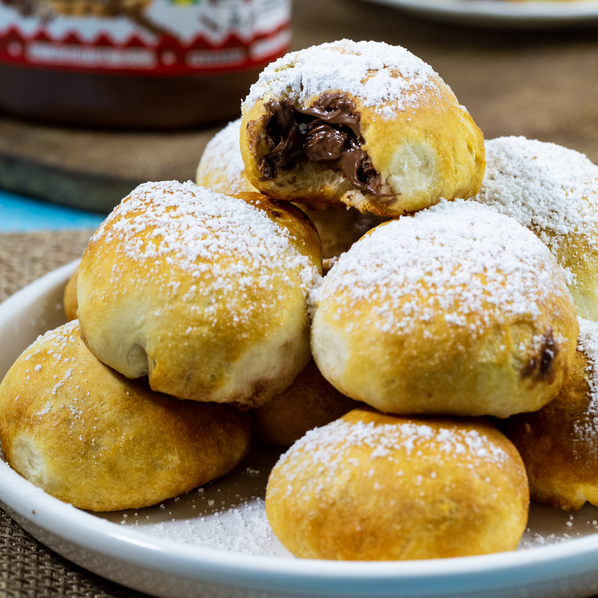 Air Fryer Nutella Bombs stacked on a plate.