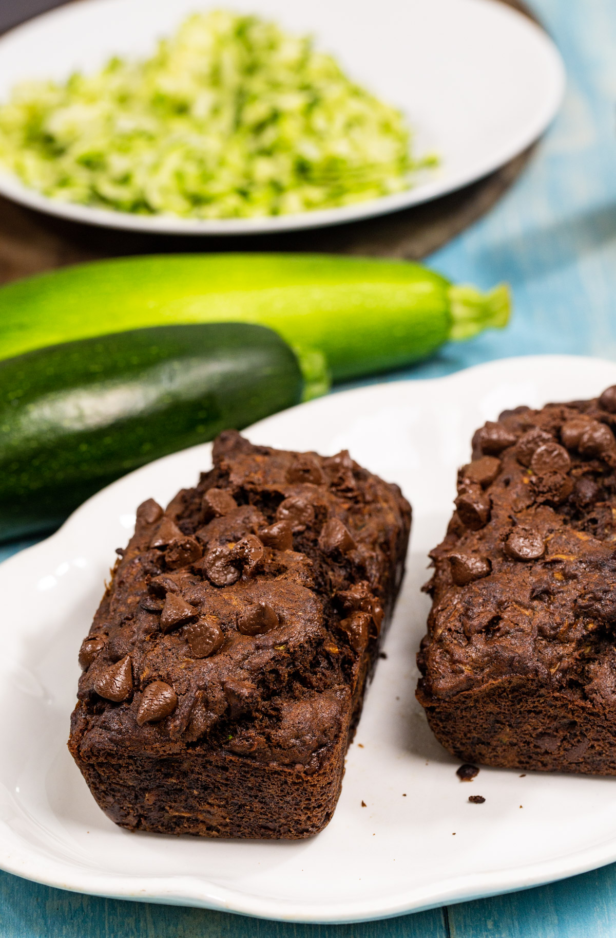 Two loaves of Chocolate Zucchini Bread on plate.
