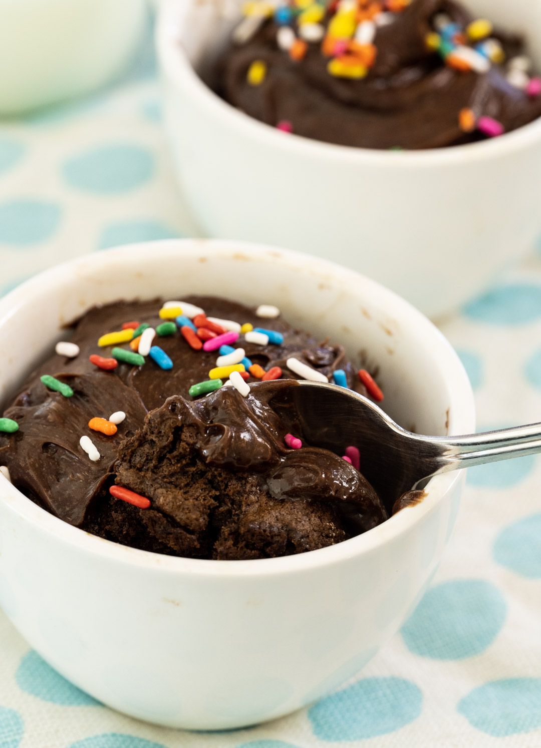 Spoon scooping into mug cake.