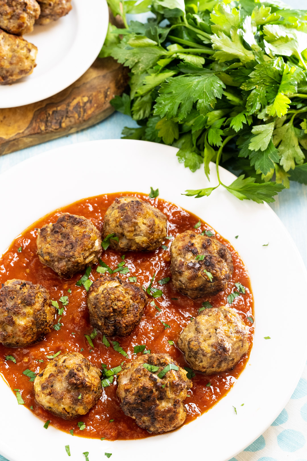 Air Fryer Italian Meatballs on a plate with marinara sauce.