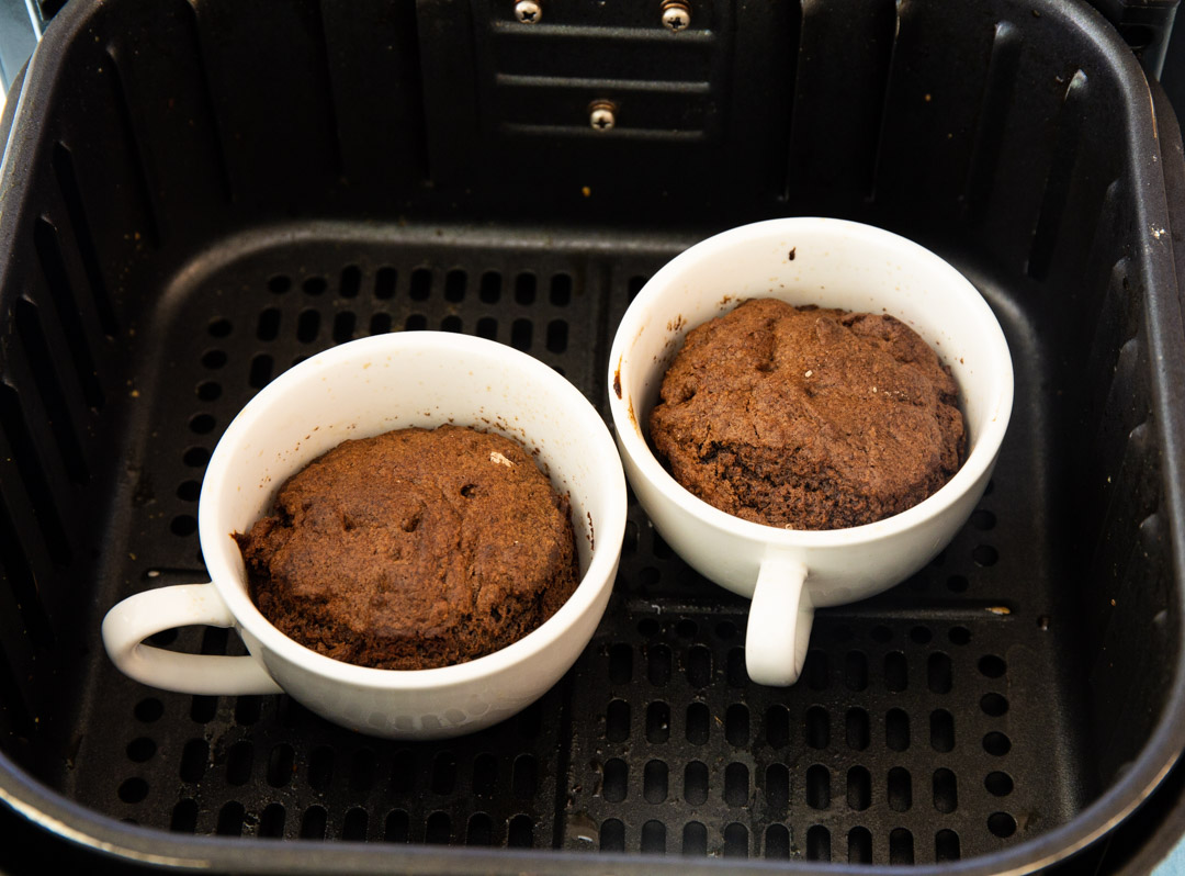 Cooked cakes in air fryer basket.