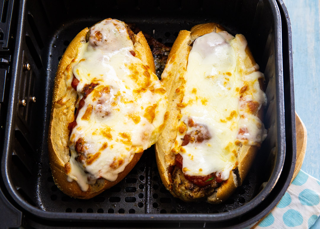 Meatball Subs in air fryer basket.