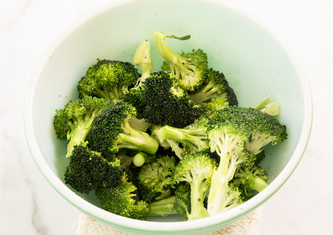 Uncooked broccoli in a bowl.