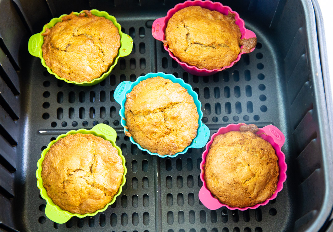 Baked cupcakes in air fryer basket.