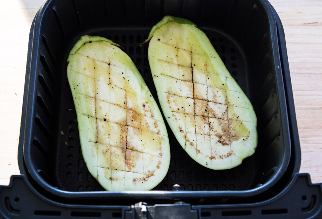 Eggplant halves in air fryer.