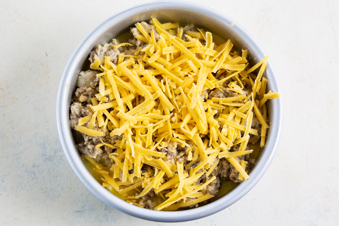 Sausage gravy and cheese on top of biscuits.