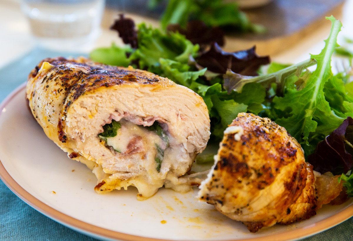 Air Fryer Ricotta Chicken Roll-up cut in half.
