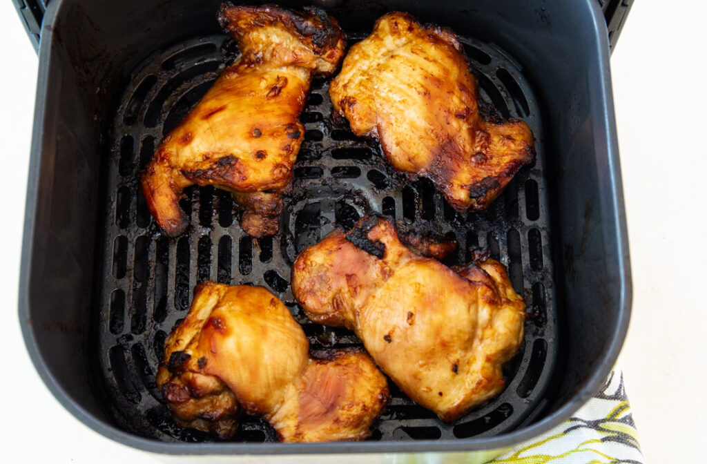 Teriyaki Chicken in air fryer basket.