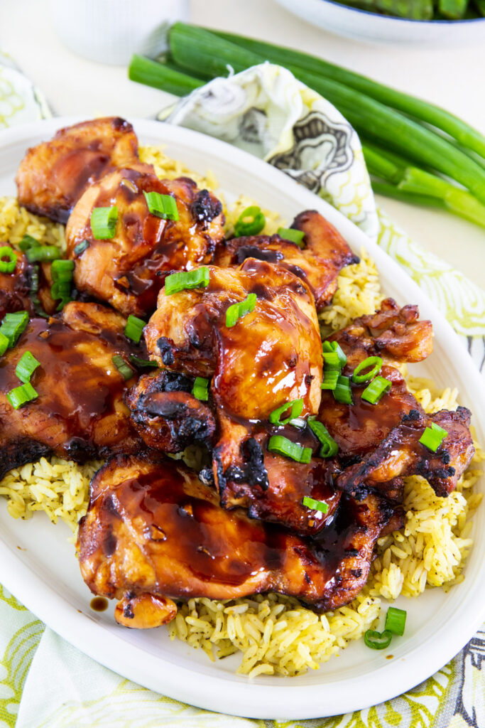 Air Fryer Teriyaki Chicken over rice on a serving plate.