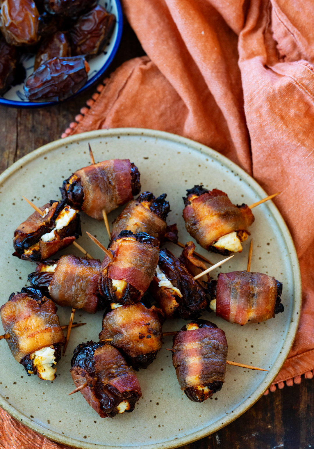 Stuffed Dates with toothpicks on a plate.